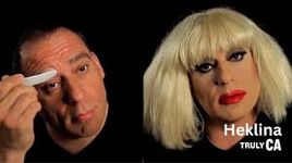 Before-and-after photo of drag artist Heklina applying makeup and wig in front of a black background. Heklina has light skin and black hair - the wig is a blonde bob which contrasts sharply with the dark eyeliner and bright red lipstick.